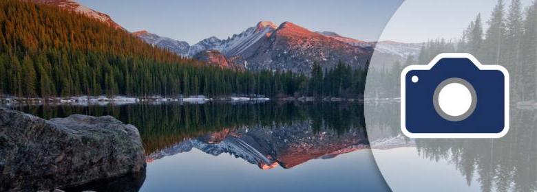 camera icon over serene mountain lake scene banner